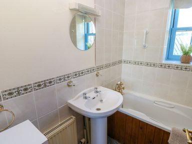 A bathroom with a sink and a bathtub at Casa Mia in Goodwick