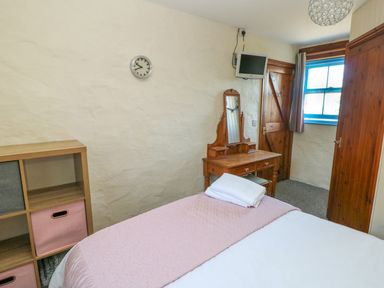 A bedroom with a bed and a dresser at Casa Mia in Goodwick