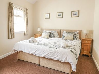 A bedroom with a double bed and bedside tables at Cottage No 9 in Keswick