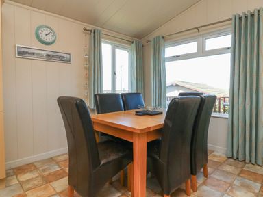 A dining room with a table and chairs at 1 Ocean Terrace in Ilfracombe