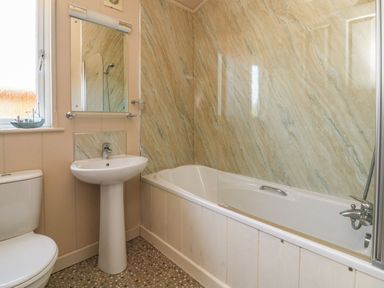A bathroom with a shower, sink, and bathtub at 1 Ocean Terrace Ilfracombe
