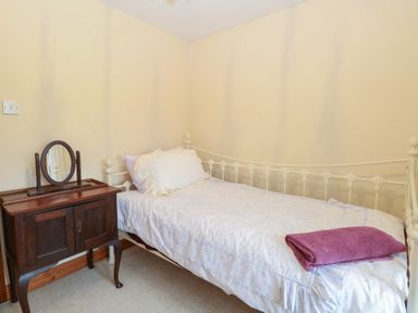 A bedroom with a bed and a dresser at Mabby in Caister-On-Sea