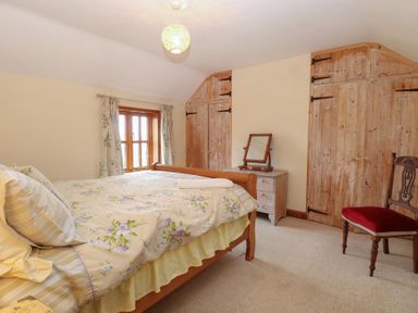 A bedroom with a bed and dresser at Mabby in Caister-On-Sea