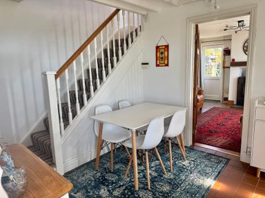 A dining room with a table and chairs at Penpegws near Aberystwyth