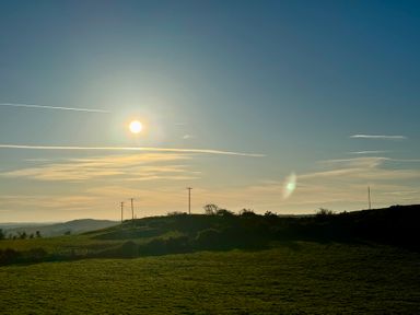 A landscape view featuring sun and hills at Penpegws near Aberystwyth