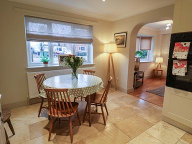A kitchen with a dining table and chairs at Cliff Cottage