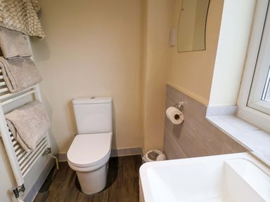 A bathroom with a toilet and towel rail at Cliff Cottage