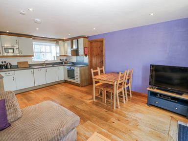 A kitchen with a dining table and chairs at Swallows Rest in Hexham