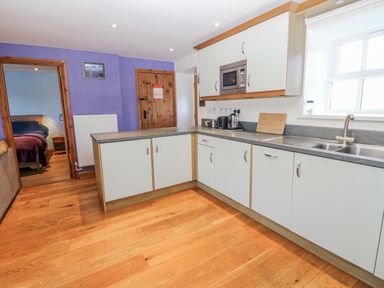 A kitchen with cabinets and appliances at Swallows Rest in Hexham