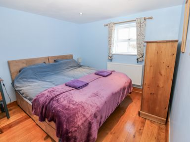 A bedroom featuring a bed with blankets and towels at Swallows Rest in Hexham