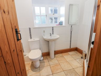A bathroom with a toilet and sink at Swallows Rest in Hexham