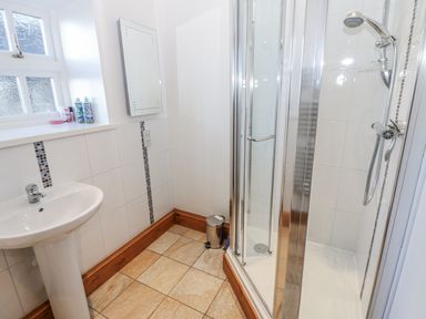 A bathroom with a sink and shower at Swallows Rest in Hexham