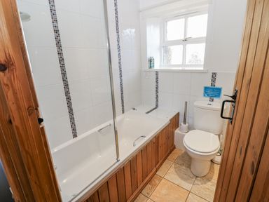 A bathroom featuring a bathtub and toilet at Swallows Rest in Hexham