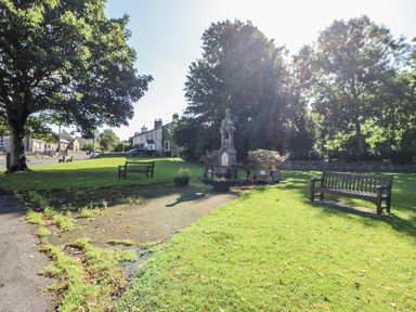 A park with benches and a memorial at Swallows Rest in Hexham