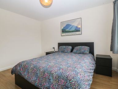 A bedroom with a bed and nightstand at Orme View in Penmaenmawr