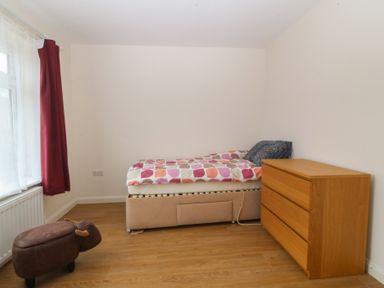 A bedroom with a bed and a dressing table at Orme View in Penmaenmawr