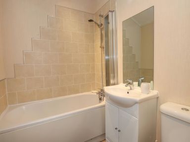 A bathroom with a bathtub, sink, and toilet at Tiggywinkle Beck - White Cross Bay in Windermere