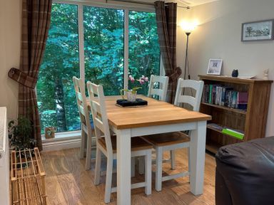 A dining room with a table and chairs at Owls House - White Cross Bay Windermere