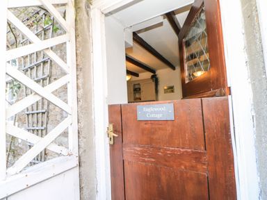 An entrance door with a sign at Englewood Cottage in Hexham