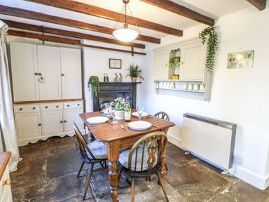 A dining room with a table and chairs at Englewood Cottage in Hexham