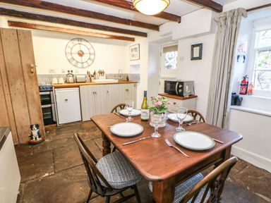 A kitchen with a table and chairs at Englewood Cottage in Hexham