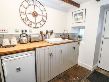 A kitchen with a sink and appliances at Englewood Cottage in Hexham
