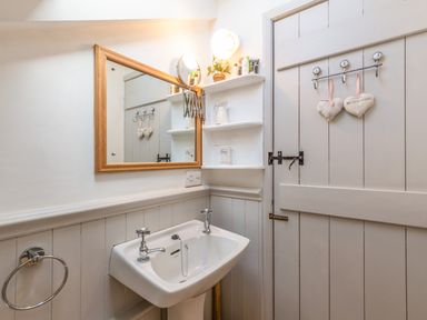 A bathroom with a sink and mirror at Englewood Cottage in Allenheads