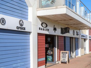 A storefront displaying Crocs and Oakley at Flat 1 Lee Cliff Park Dawlish Warren