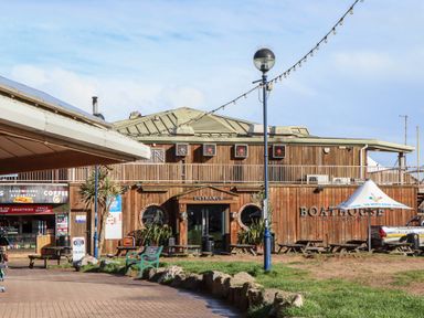 An outdoor area with a wooden building and seating at Flat 1 Lee Cliff Park in Dawlish Warren