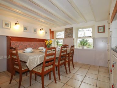 A dining room with a table and chairs at Plenteth in Truro