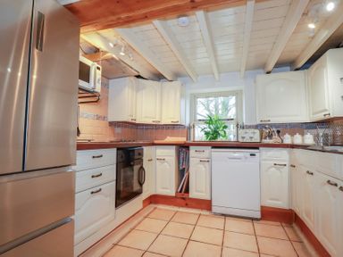 A kitchen with appliances and cabinets at Plenteth in Truro