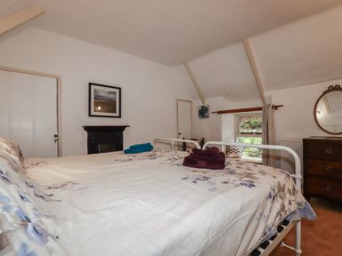 A bedroom with a bed and a window at Plenteth in Truro