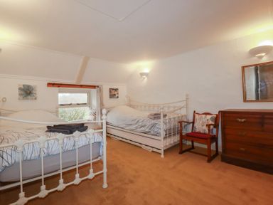 A bedroom with two beds and a dresser at Plenteth in Truro