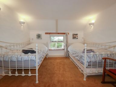 A bedroom with two beds and a window at Plenteth, Truro