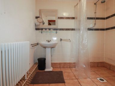 A bathroom with a shower and sink at Plenteth, Truro