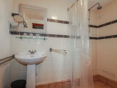 A bathroom with a sink and shower at Plenteth in Truro