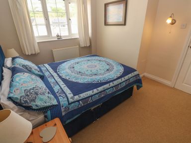 A bedroom with a bed and window at 16 Forth An Nance Portreath