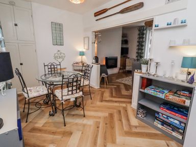 A dining room with a table and chairs at 55 Meldon terrace Newbiggin-by-the-Sea