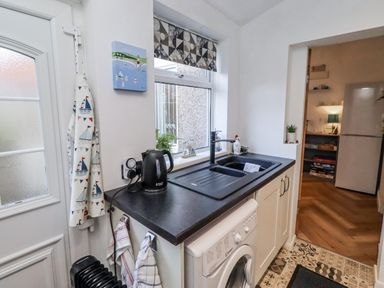 A kitchen with a sink and washing machine at 55 Meldon terrace Newbiggin-by-the-Sea