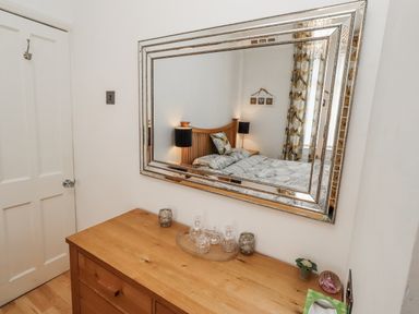 A bedroom with a bed and chest of drawers at 55 Meldon terrace Newbiggin-by-the-Sea