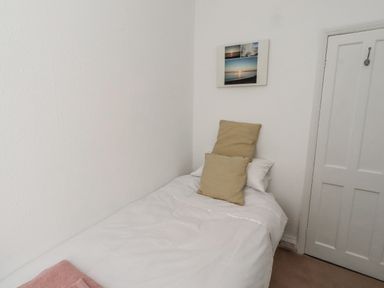 A bedroom with a bed and pillows at 55 Meldon terrace in Newbiggin-by-the-Sea