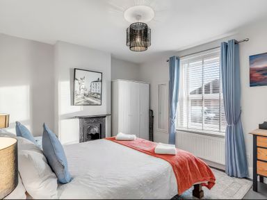 A bedroom with a bed and wardrobe at Bay Tree Cottage in Heacham