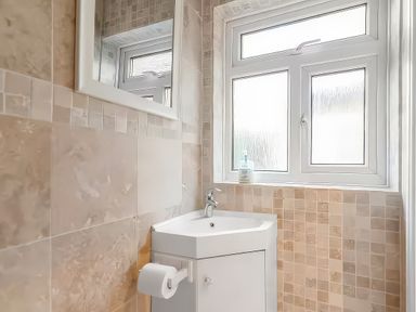 A bathroom with a sink and toilet at Bay Tree Cottage in Heacham