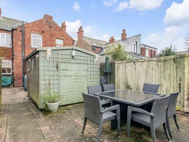 A garden with a table and chairs at Bay Tree Cottage in Heacham