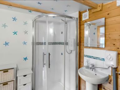 A bathroom with a shower and sink at Bay Tree Cottage in Heacham