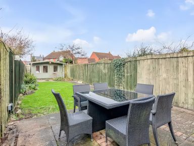 A garden with a table and chairs at Bay Tree Cottage in Heacham