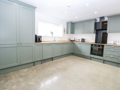 A kitchen with cabinets, sink and appliances at The Ivy in Norwich