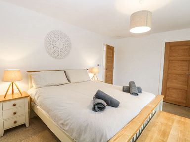 A bedroom with a bed and bedside tables at The Ivy in Norwich