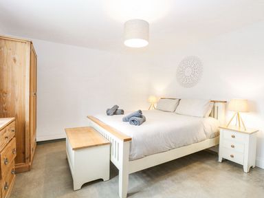 A bedroom with a bed and wardrobe at The Ivy in Norwich