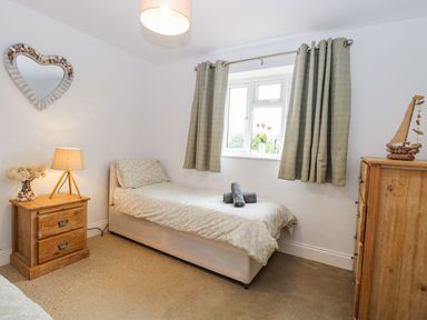 A bedroom with a bed and nightstand at The Ivy in Norwich